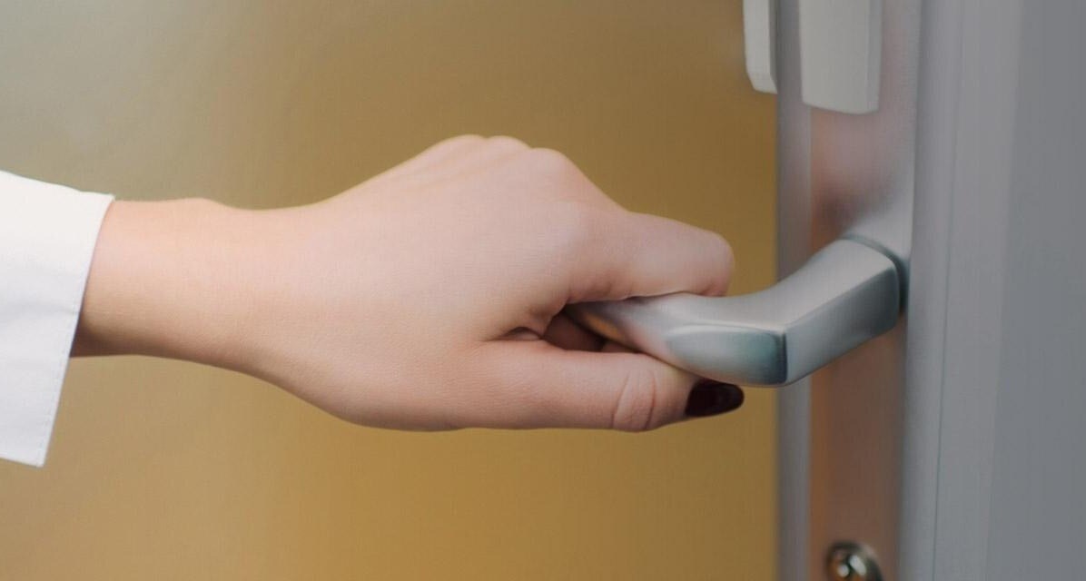 Closeup of woman's hand opening door of medical office