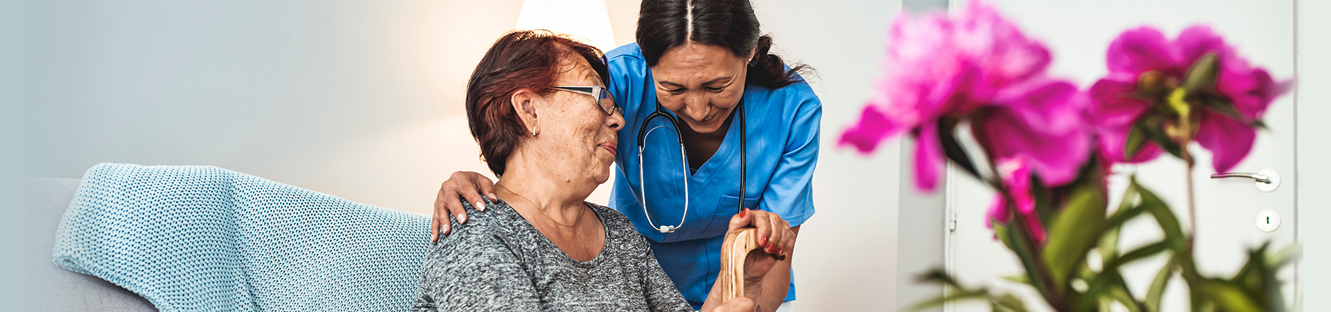 A senior and a medical worker laugh together