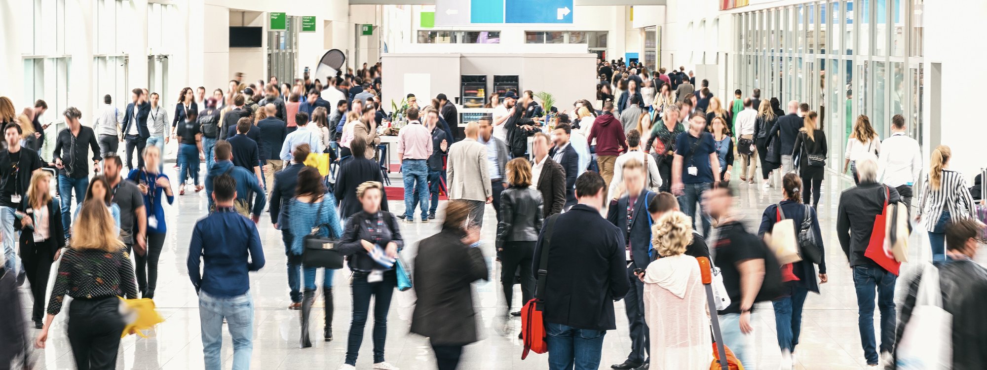 A busy trade show floor bustling with people