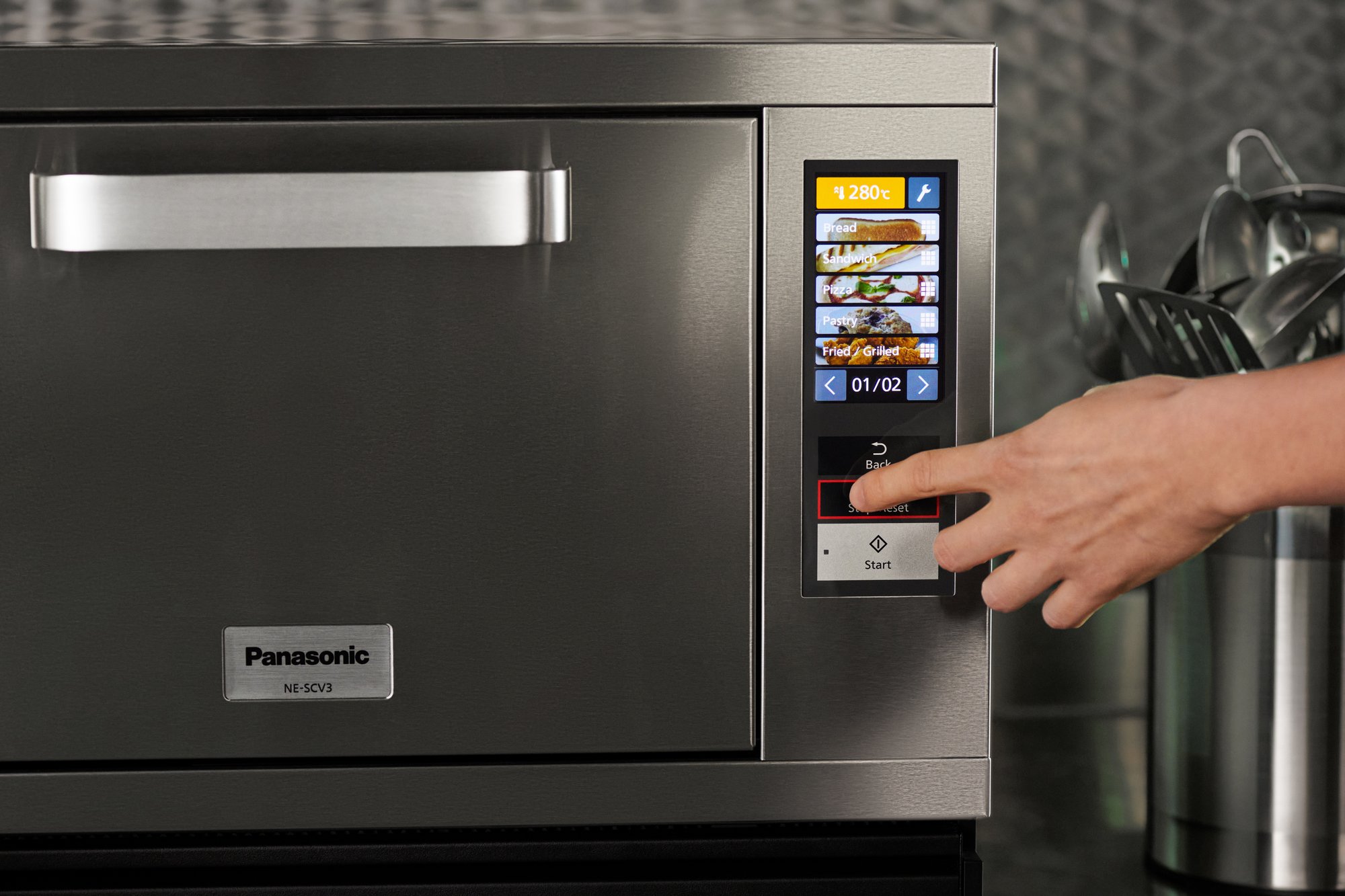 A person’s hand setting up recipe on Panasonic NE-SCV3N high speed oven digital menu.