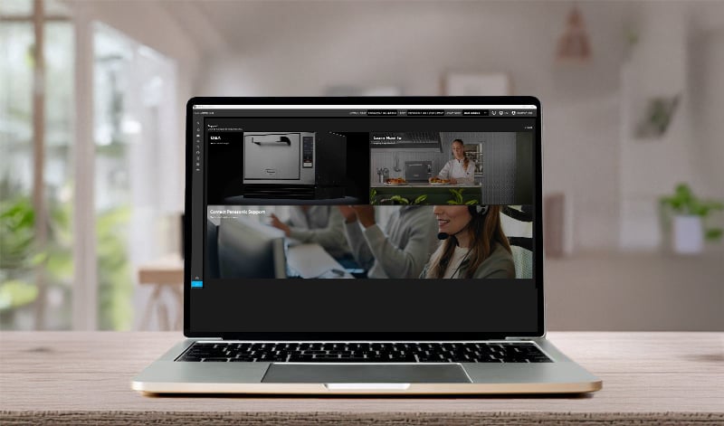 A laptop on a wooden table displays the SCV Control Hub app's in-app support section, showing tutorial thumbnails and interface previews on the screen.