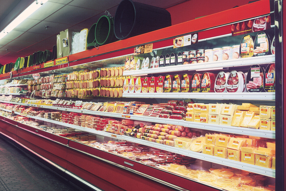 Fully stocked refrigerator wall at grocery store