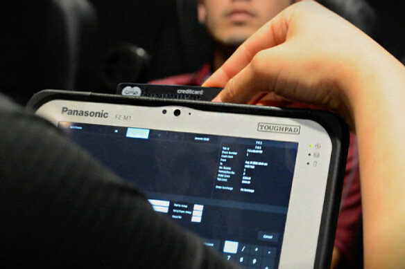 Person using Toughbook laptop with point-of-sale system on screen