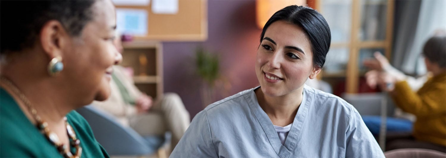 A nurse speaks with a woman