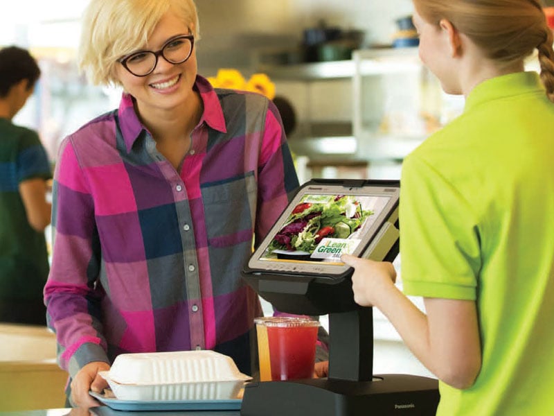 A woman orders at a fast food counter