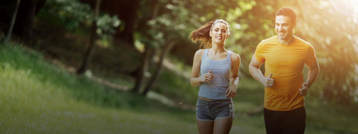 A young couple jogs on a sunny day