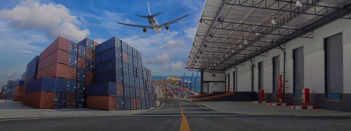 An airplane takes off over a shipping yard