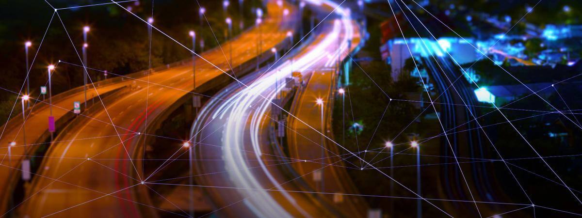 A time-lapse photo shows traffic on a highway as streaks of light