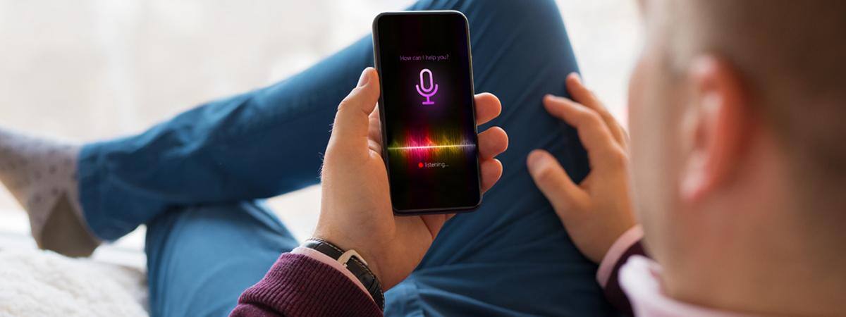A man speaks a voice command to his phone