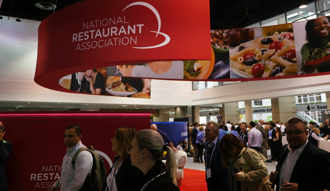 National Restaurant Association banner over busy show floor