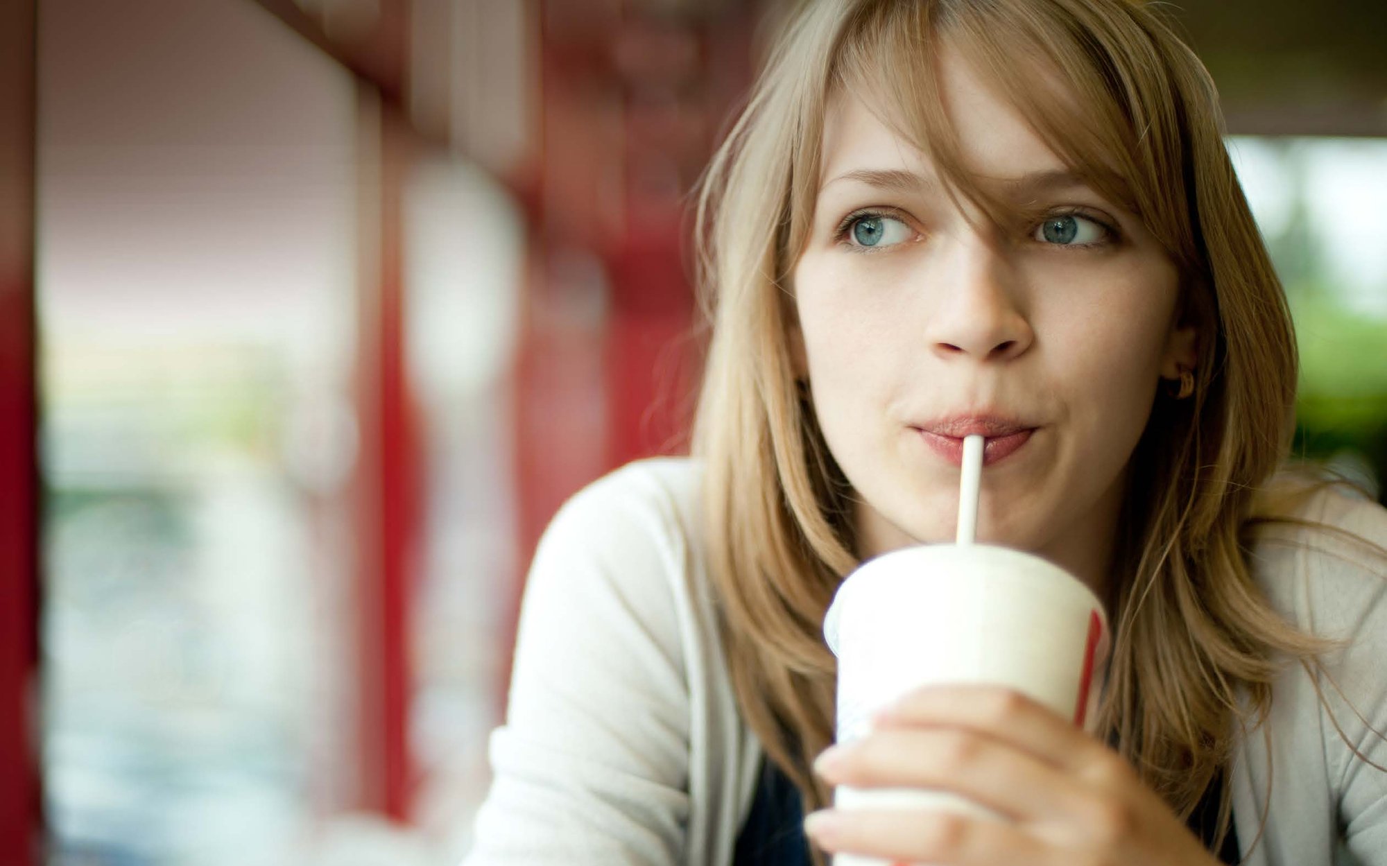 A girl drinks from a straw