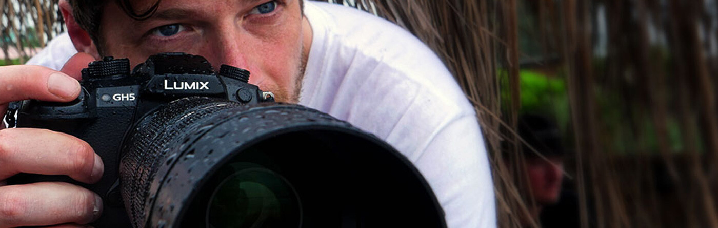 Man looks down lens of camera