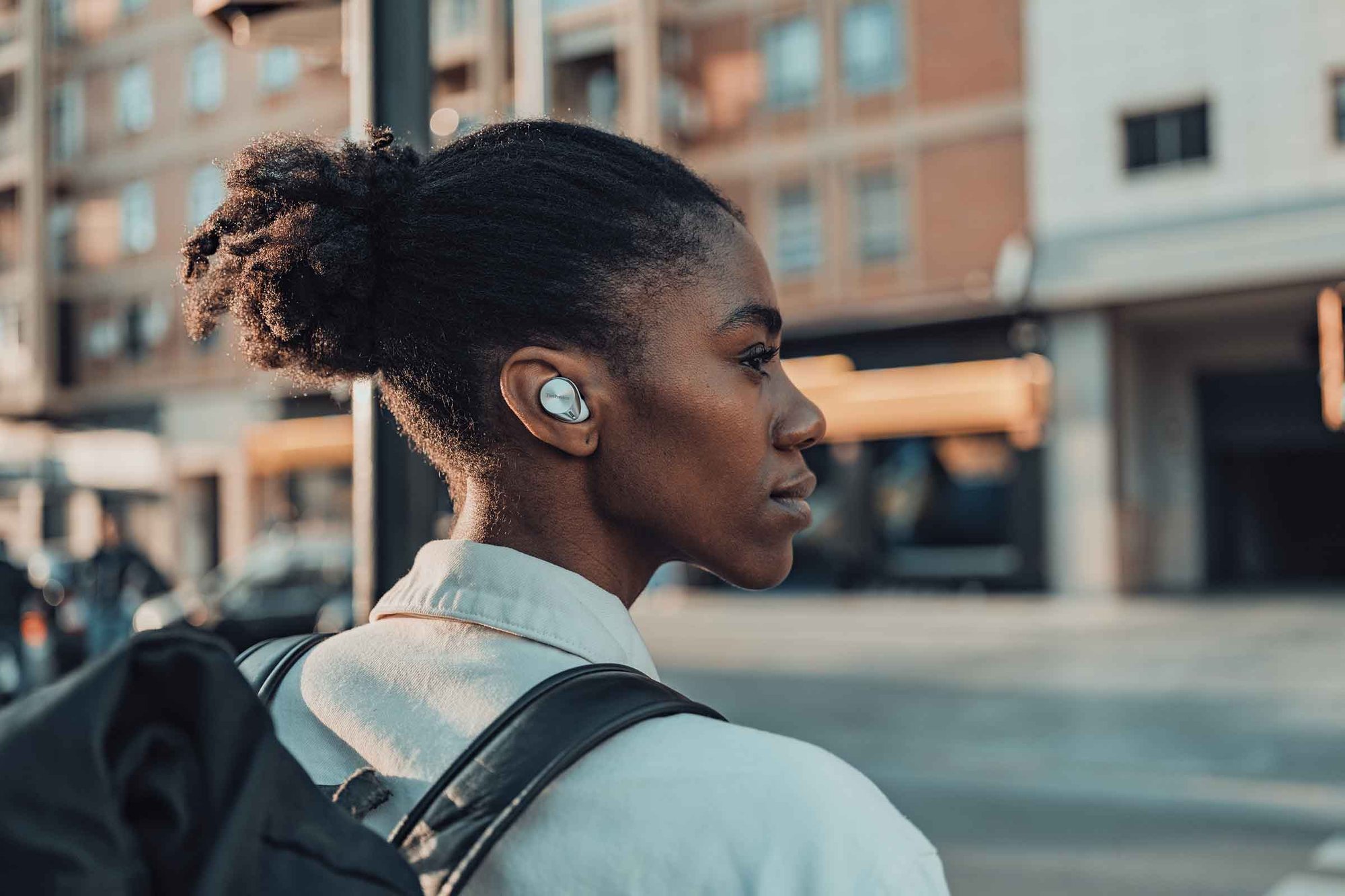 Person wearing wireless earbuds