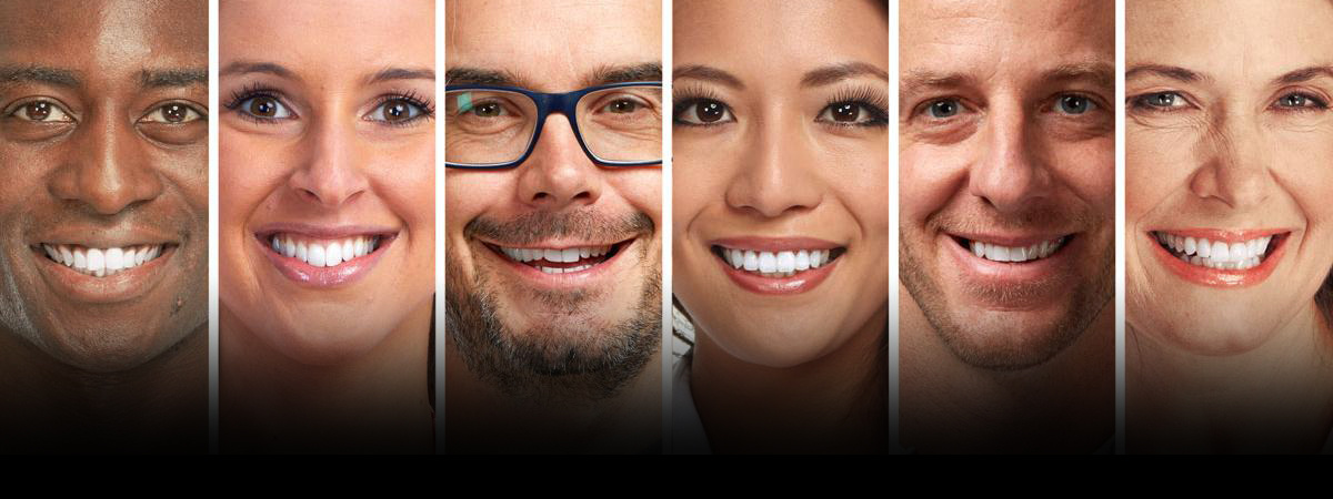 A row of smiling faces with white teeth