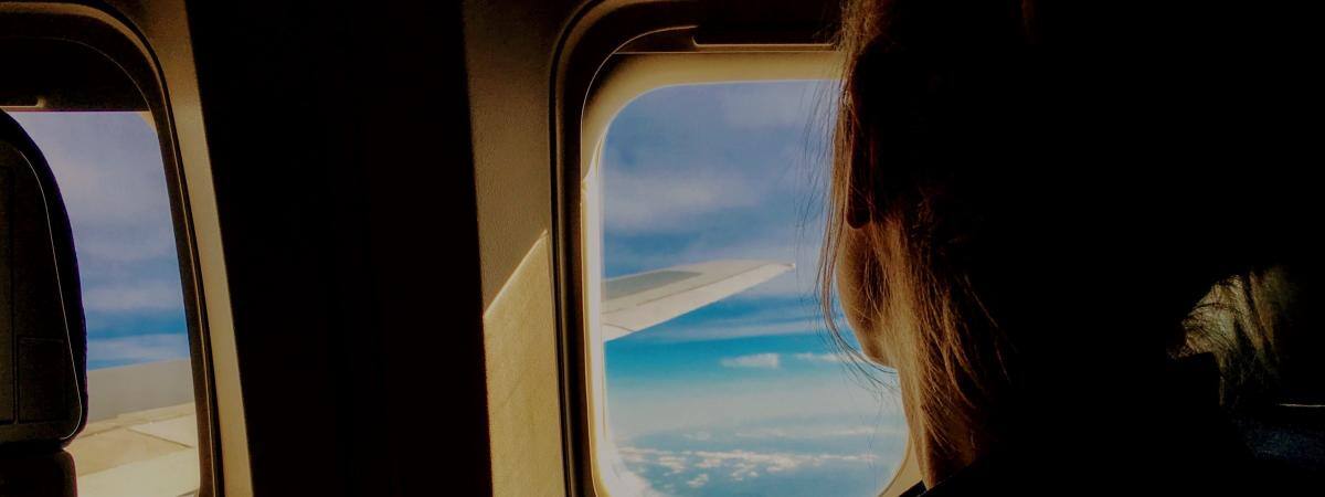 Woman looking out airplane window