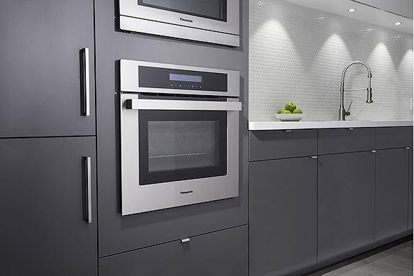 Built-in oven installed in a modern kitchen with gray cabinetry.