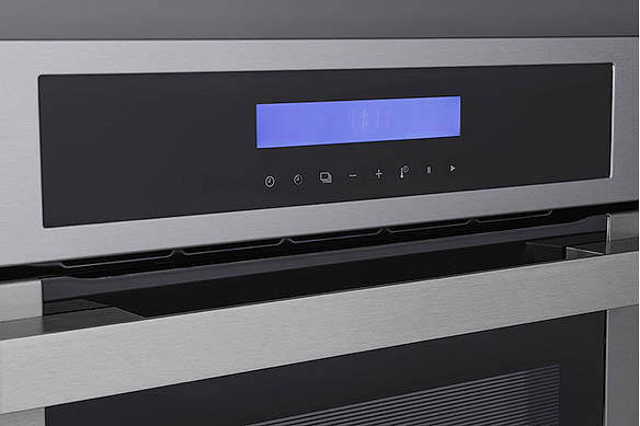 Close-up of a built-in oven with digital display and touch controls.