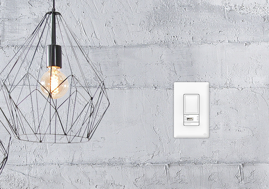 Swidget smart switch installed in concrete wall next to modern hanging light fixture