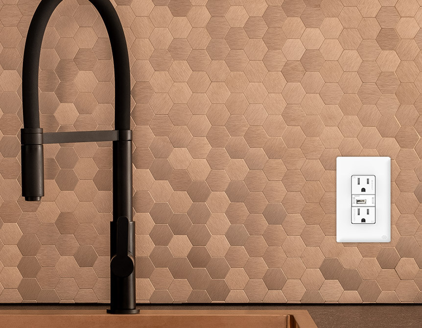 Swidget smart outlet installed in modern kitchen backsplash next to sink