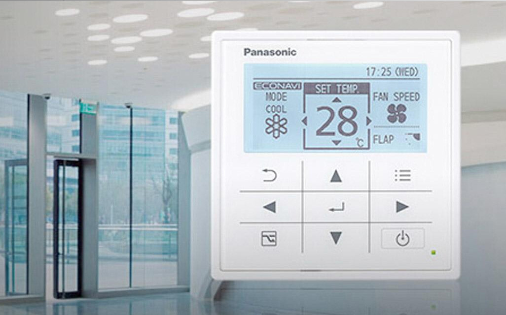 Image of Panasonic controller with temperature and system information displayed overlaid on image of office building entrance