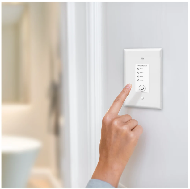 Low voltage time mounted on white wall and index finger is about to press a button on it