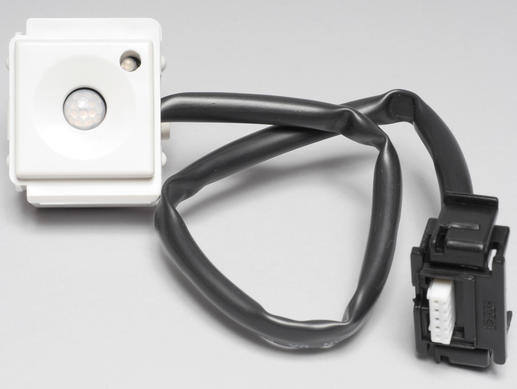 White motion sensor module with attached black cable and connector.