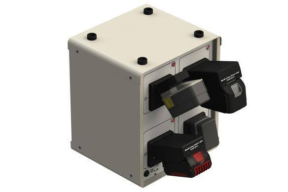 Four-bay battery charger with batteries inserted, isolated on white.
