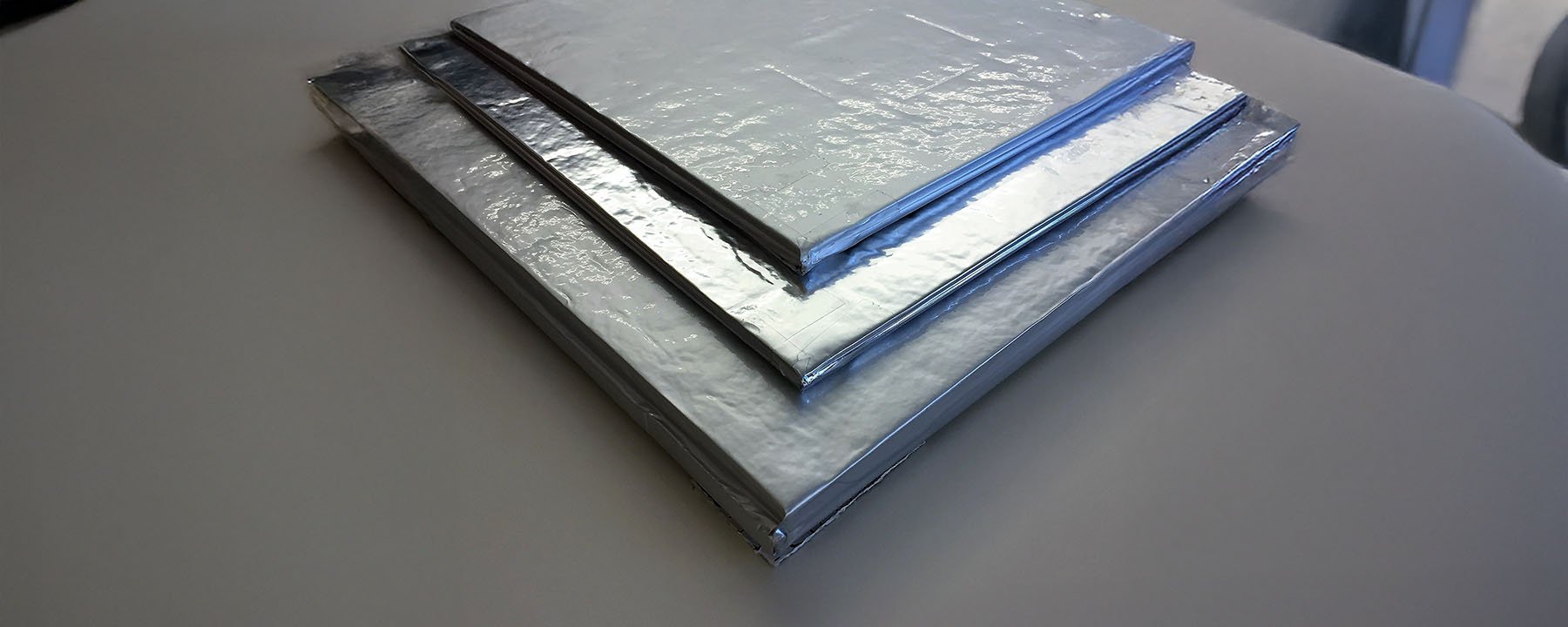 Three vacuum insulation panels stacked on top of eachother