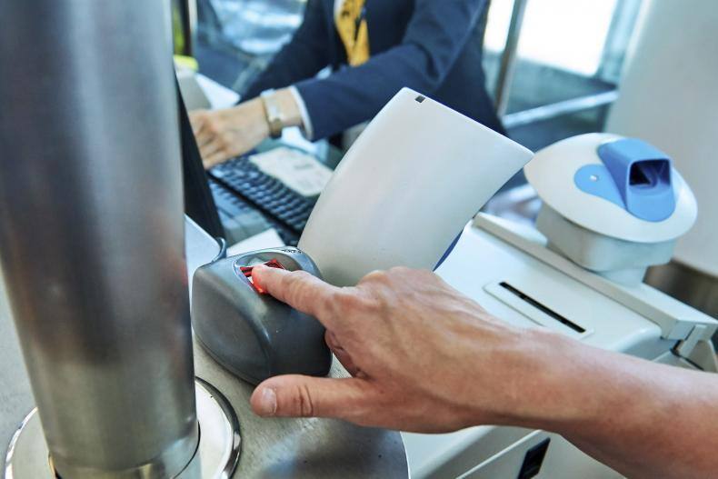 A hand performing a fingerprint scan