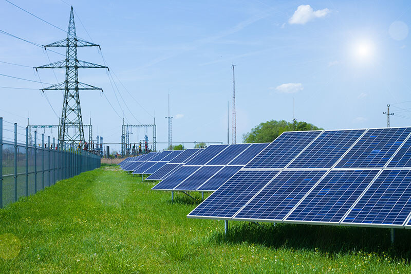 A row of large solar panels in a field