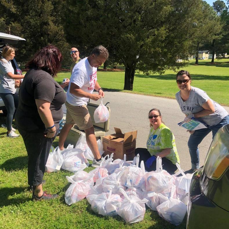 Dave Tomicki organizes bags of food for distribution