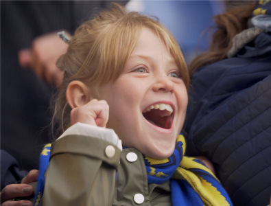 A child cheers at a sports event