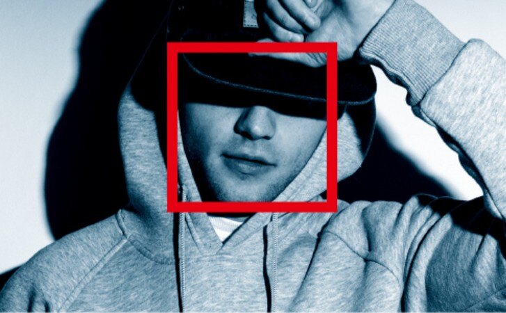 A man's face with a red box around it