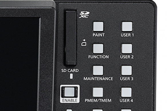 Close-up of a controller with labeled buttons and an SD card slot.