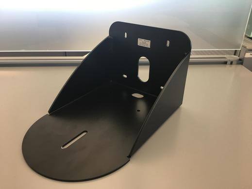 Support mural noir pour les caméras PTZ sur une table blanche.